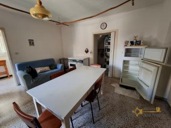 Two-bedroom stone house in habitable conditions with two cellars and outbuilding/garage. Guilmi Img7